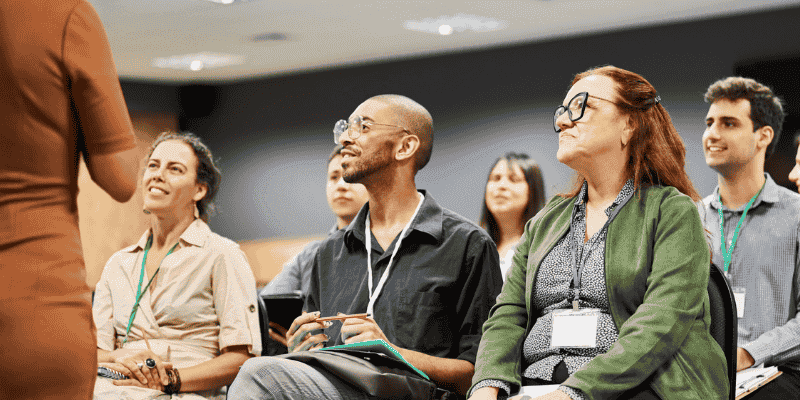 Group of people listening to a speaker during a conference event at convention centre.